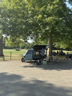 Open space ahead to coffee van on back. A-framed sign to its right.