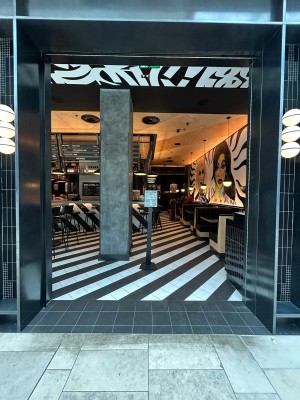 Opening ahead leads to seating area. Black waiting stand in centre.