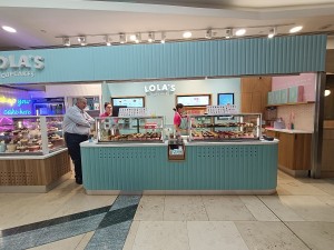 From path, facing venue. Display and counter along back.