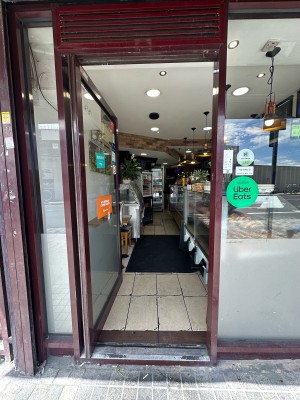 Glass door with brown frame. Push silver handle from right to open.
