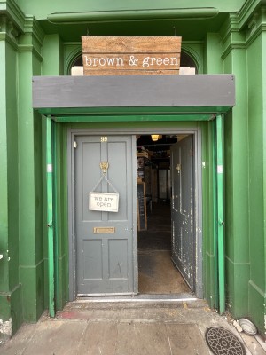 Grey wooden doors ahead. Push from centre to open.