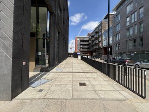 From Wyke Rd, facing Lanterna building. Ramp up ahead with handrail along right.