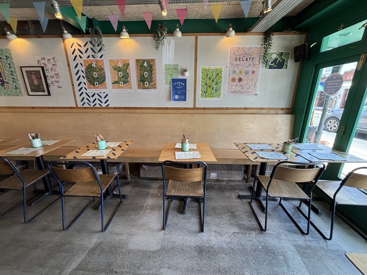 From end of table facing straight. Half booths along back wall.