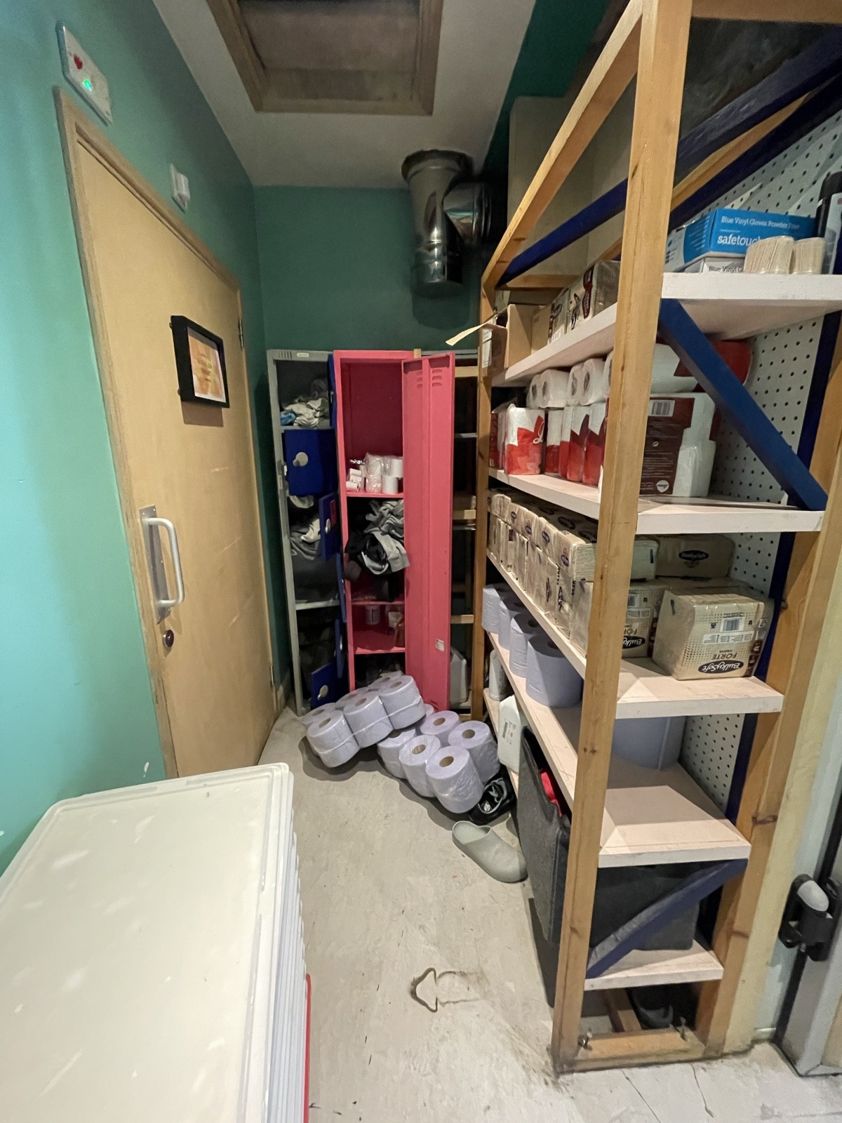 From end of path facing right. Storage cabinets along right and back. Bathroom door at back left.