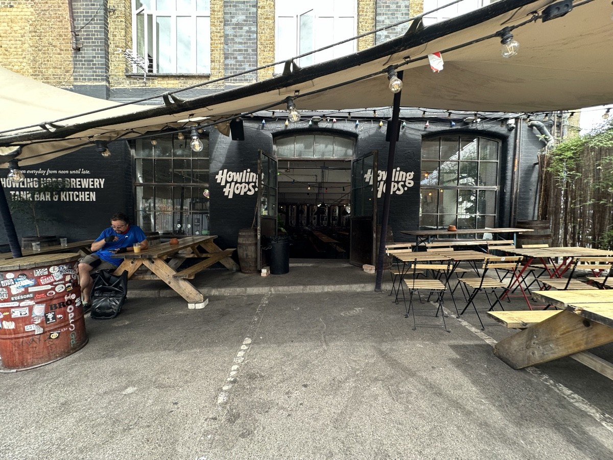 From opening facing straight. Picnic benches go left and right. Tables and chairs go back right. Centre path leads to second entrance.