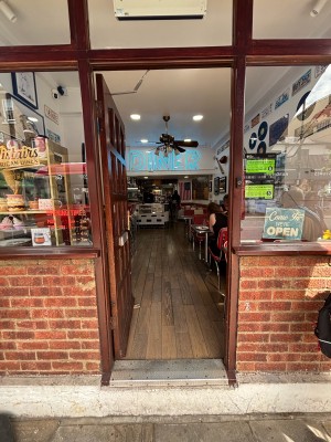 Brown door with glass panels ahead. Push from right to open.