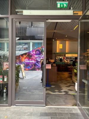Glass doors with grey frames. Pull from centre to open.