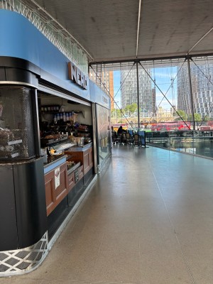 From station facing venue. Counter on left. Open space on right.
