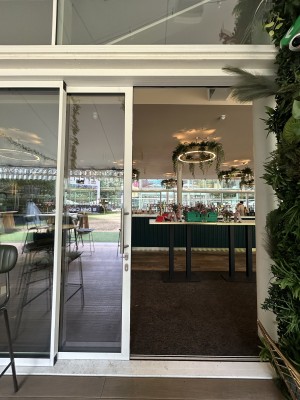 Sliding glass door ahead with white frame. Slide silver handle from right to left to open.