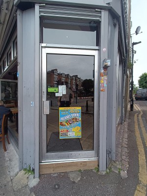 Glass doors with grey, metal frame. Push from left to open.