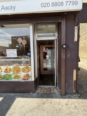 Glass door with metal frame ahead. Push from left to open.