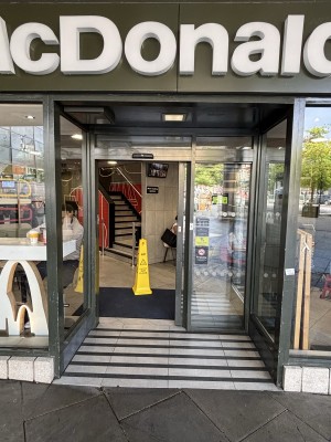 Glass door with black, metal frame at back. Door slides from left to open.