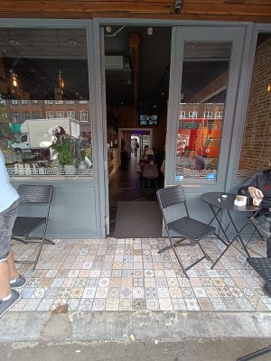Glass door with grey, wooden frame ahead. Push from right to open.