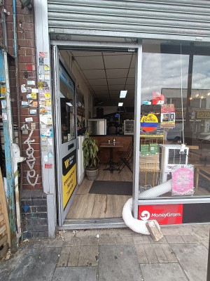 Glass door with grey, metal frame. Push from right to open.