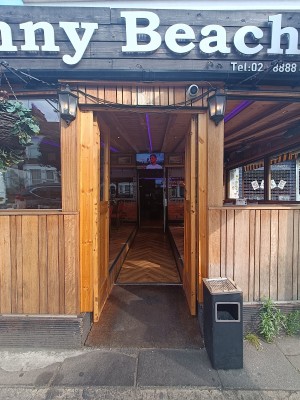 Glass door with brown, wooden frame ahead. Push from right to open.
