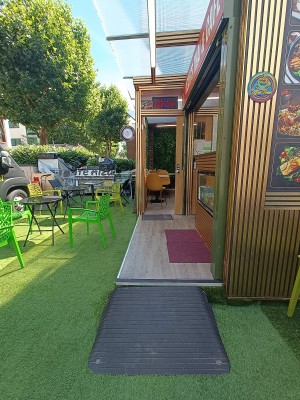 From street, facing venue. Opening ahead to counter and seating.