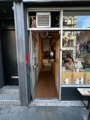 Glass door with metal frame ahead. Push from handle on right to open.