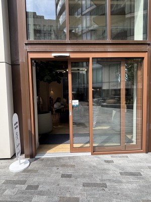 Glass doors with brown frame ahead. Left door slides from left to open.