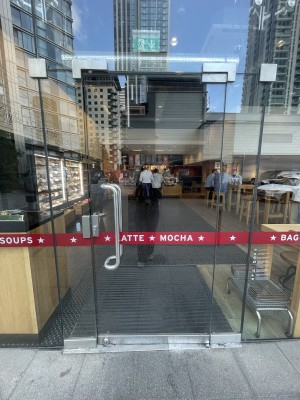 Glass door ahead. Push silver metal on left to open.