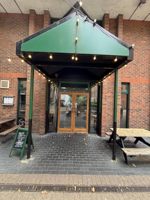 Open archway ahead. Glass doors with wooden frame on back. Pull doors to open via handle in center.