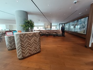 From landing, facing left. Welcome desk on left. Opening at back to seating.