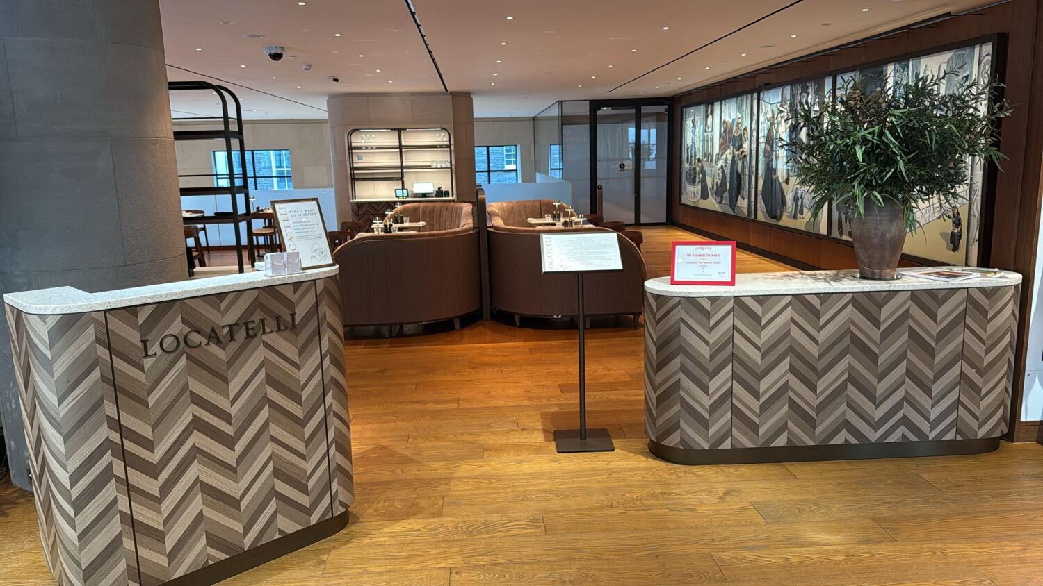 From welcome desk facing straight. Half-booth along back.