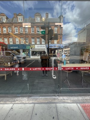 Glass door ahead. Push silver metal handle on right to open.