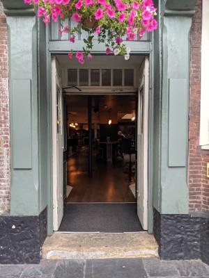 White doors with glass panels. Push from centre to open.