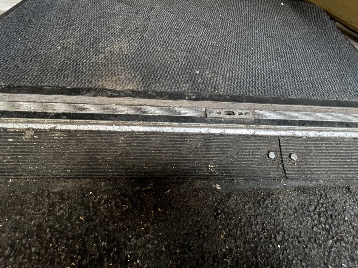 Bump at foot of door followed by doormat