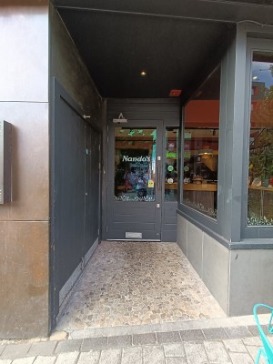 From outdoor area, facing doorway. Opening ahead. Doorway at back.