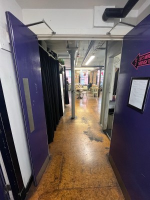 Purple wooden doors with silver handles. Pull handles from centre to open.