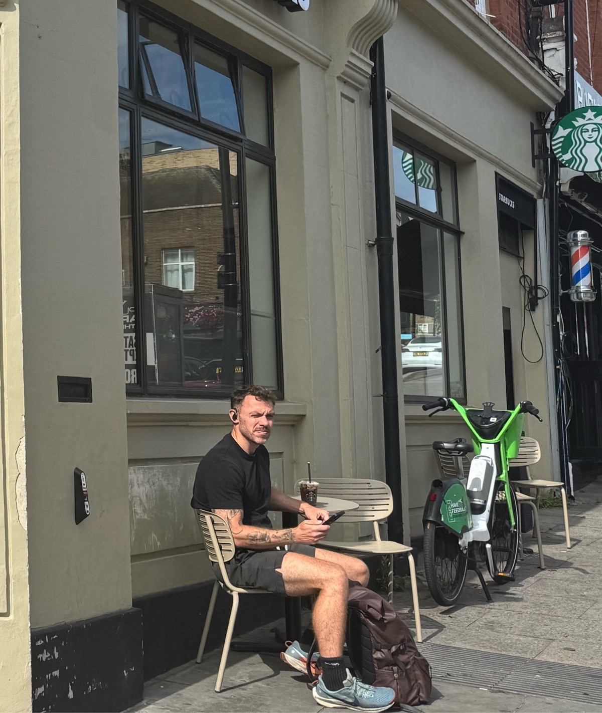Outdoor takeaway window at seating height allows orders without entering; currently blocked by chairs, often obstructed by bikes or passersby.