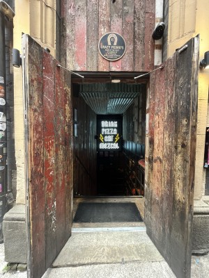 Brown, wooden doors ahead. Pull black, handles in middle to open.
