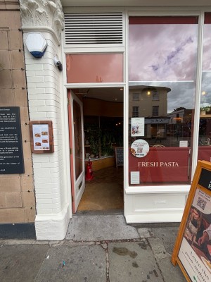 Glass door with white frame ahead. Push from right to open.