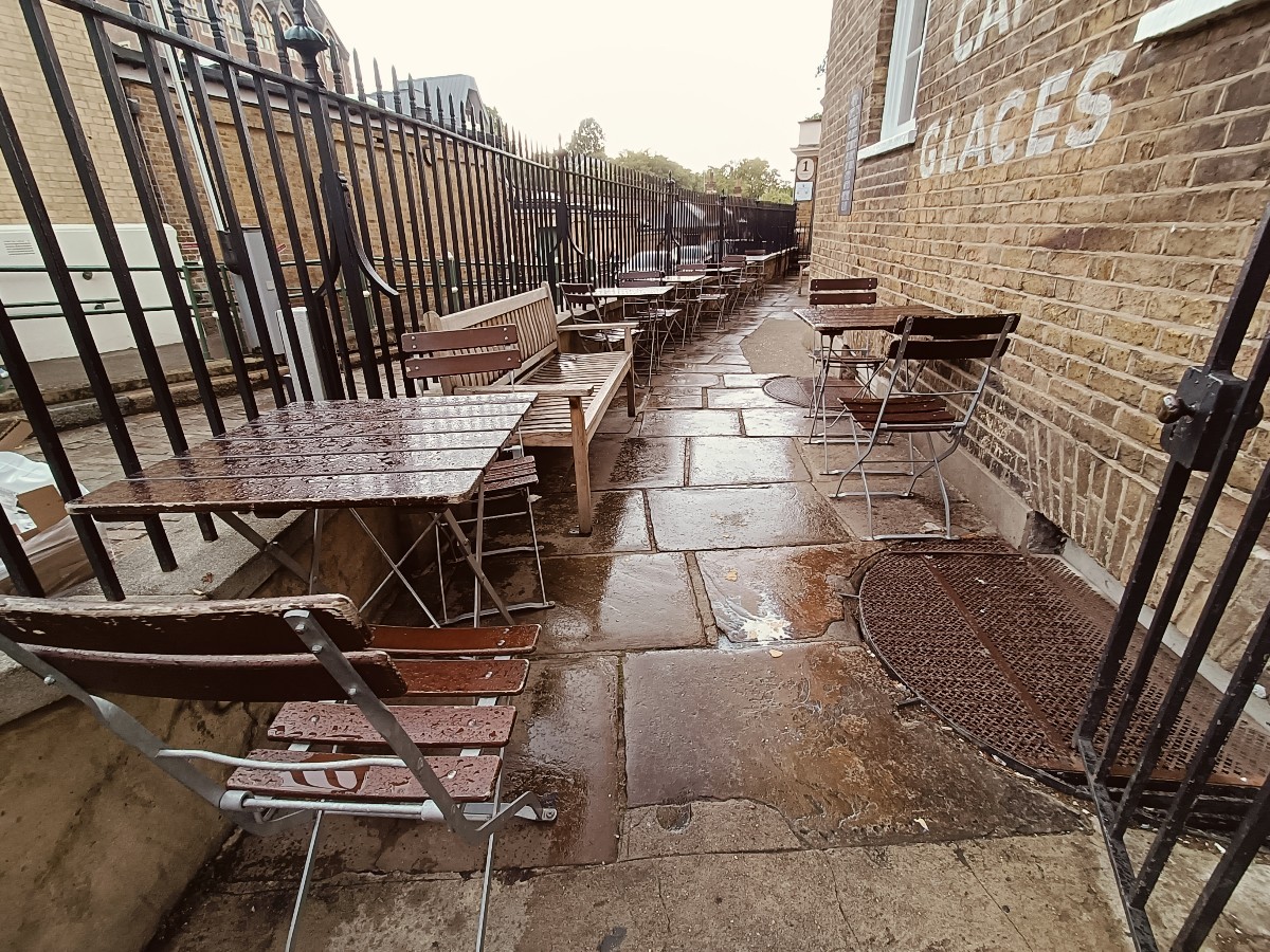 From doorway, facing straight. Tables and chairs along both sides.