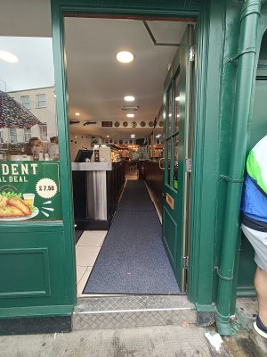 Glass doors with green wooden frame. Push from left to open.