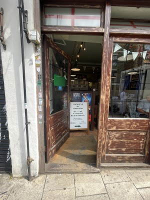Brown wooden and glass door ahead. Push gold metal handle from right to open.