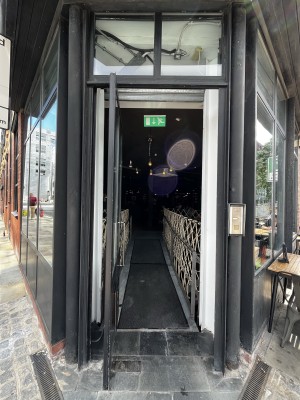 Glass door ahead. Push from metal handle on right to open.