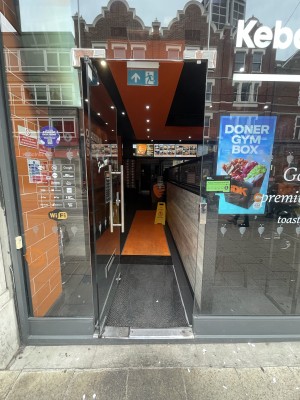 Glass door ahead. Push silver metal handle from right to open.