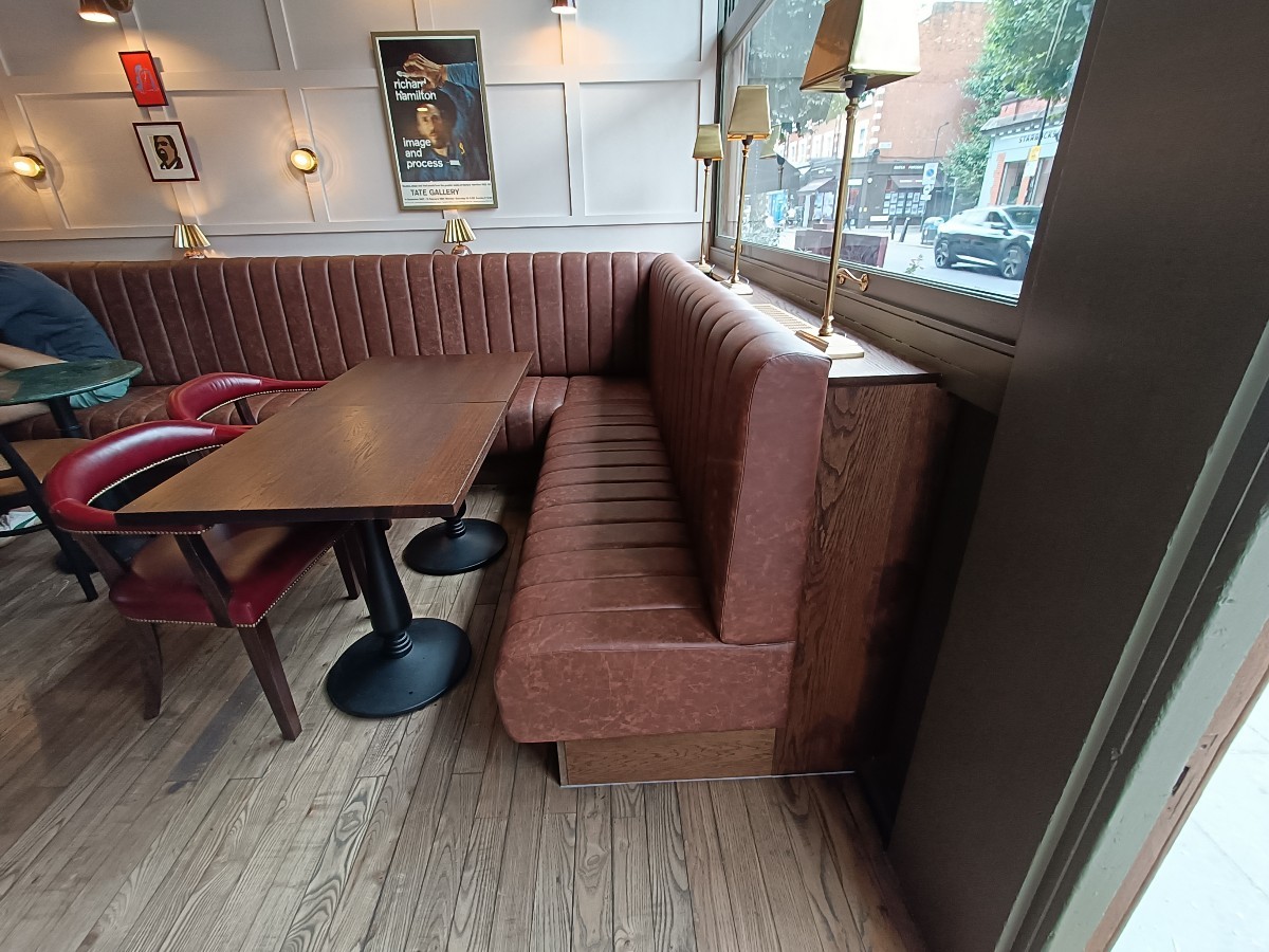 From entrance, facing right. Half-booths and chairs at back and along back left.