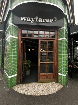 Glass doors with wooden frames. Push from metal pad in centre to open.