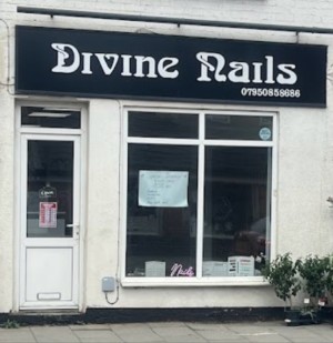 Entrance to divine nails. There is a door on the left of the photo which has 1 step into the shop.