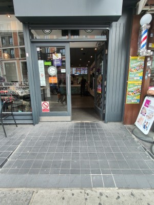 Built-in ramp going up to grey framed glass doors. Push silver handles in centre to open.