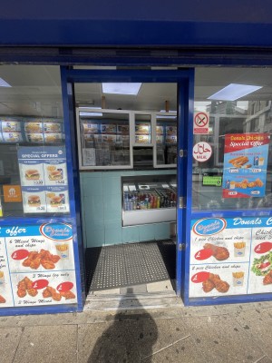 Glass door with blue frame ahead. Slide from left to right to open.