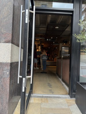 Glass panelled door propped open. Handle on the right pull too open.