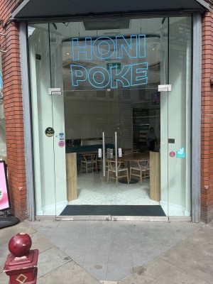 Glass doors with metallic handles in centre. Push to open.