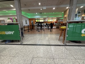 Restaurant barriers on right and left side. Retail area straight. Queue cords straight ahead.