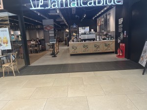 Open archway with outdoor seating to its left.