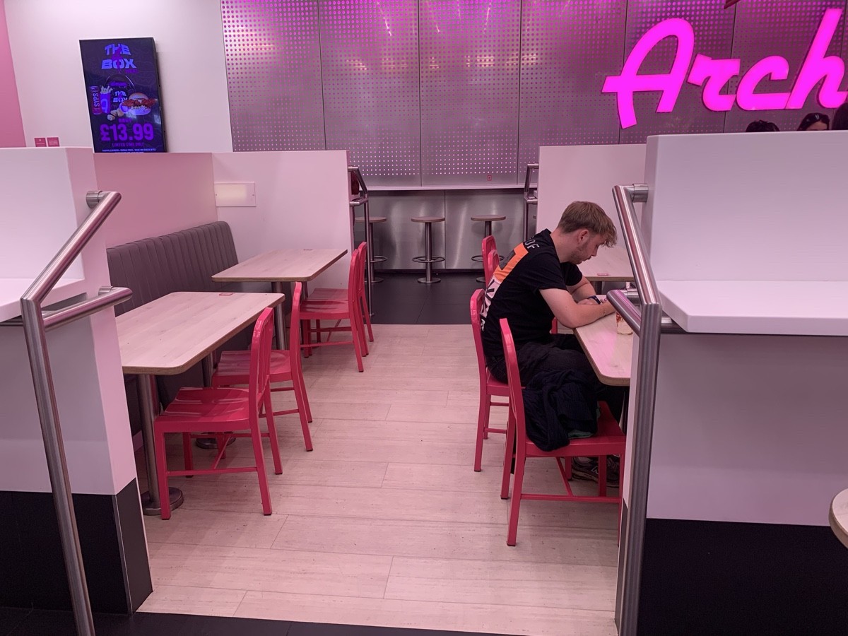 From half booths facing left. Side seating space. Half booths on right and left.