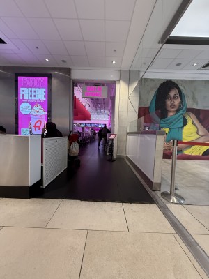 Entrance to venue. Path straight to main area. Metal wall on left side.